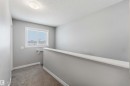 This area features a window, gray walls, and carpeted flooring
