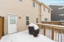 The property features a private fenced patio area with a wooden deck, accessible via an exterior door
