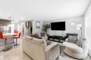 Living area featuring light-colored flooring, neutral wall tones, and recessed lighting