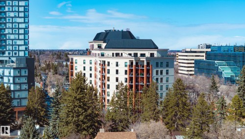 The property offers an elevated perspective of the surrounding cityscape and verdant trees