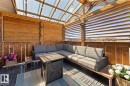 Covered outdoor structure featuring a slatted wood roof, clear panel roofing, wood-finish walls with horizontal slat details, and dark modular flooring