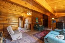 Wood-finish flooring throughout, complemented by wood-paneled walls and exposed ceiling beams