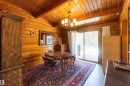 Wood-finish walls and vaulted ceiling featuring exposed beams