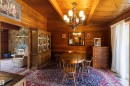 Wood paneling throughout, featuring a vaulted wood-finish ceiling with exposed beams