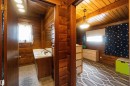 Wood-paneled interiors featuring a bathroom vanity with a white countertop and a mirrored wall