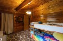 Wood-paneled walls and ceiling featuring exposed wood beams