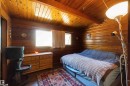 Wood-paneled room featuring a wood-finish vaulted ceiling and matching wood-paneled walls