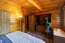Wood-paneled room featuring a wood-finish ceiling, exposed ceiling beam, and wood-finish flooring