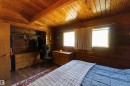 Interior room featuring wood-finish walls and vaulted wood-finish ceilings with exposed wood beams