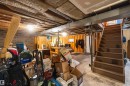 Unfinished basement space featuring a wooden staircase and exposed ceiling joists