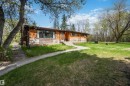 Wood-sided residence with multiple windows and a front entrance