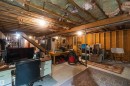 Unfinished basement with exposed ceiling joists and concrete flooring