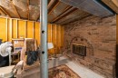 Brick fireplace with an arched opening and metal fire screen