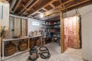 Unfinished basement space featuring exposed wood joists and concrete flooring