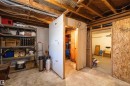 Unfinished basement space featuring exposed wood joists, concrete flooring, and partial wall framing, offering potential for customization
