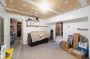 Unfinished basement area featuring exposed drywall ceiling, concrete flooring, and exposed wall studs