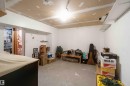 Unfinished basement area with exposed drywall ceiling and concrete flooring, featuring painted walls and a recessed lighting fixture