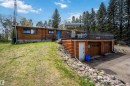 Log-sided residence with an elevated deck, two-car garage, and a separate entry door