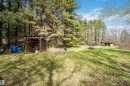 Expansive grassy area with two wood-frame sheds