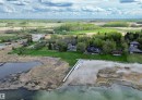 Expansive waterfront property featuring a private sandy beach, multiple docks, and direct access to a large body of water