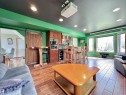 Recreation room featuring wood-finish flooring, a built-in wet bar with cabinetry, recessed lighting, and a large bay window