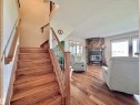 Hardwood staircase featuring wood newel posts and metal spindles