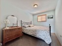 Interior room featuring light blue walls, a textured ceiling, and carpeted flooring