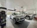 Spacious two-car garage featuring a concrete floor, white painted ceiling, and multiple overhead lighting fixtures