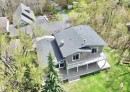 Contemporary exterior with a spacious deck and glass railings, offering extensive outdoor living