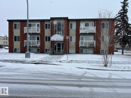 The property is a three-story building featuring a brick exterior and individual balconies