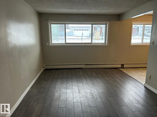 This room features wide plank flooring and a neutral color palette