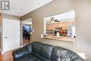 Living room with ceiling fan and light hardwood / wood-style floors