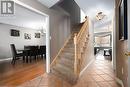 Staircase featuring wood-type flooring, a textured ceiling, and an inviting chandelier