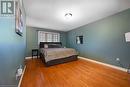 Bedroom featuring hardwood / wood-style flooring and a textured ceiling