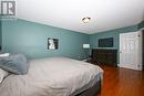 Bedroom featuring dark hardwood / wood-style floors and a textured ceiling