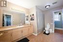 Bathroom featuring tile patterned flooring, vanity, and toilet