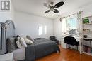 Bedroom featuring ceiling fan, a textured ceiling, and hardwood / wood-style flooring