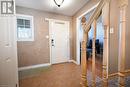 Foyer entrance with light tile patterned floors and a textured ceiling