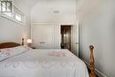 Bedroom featuring a closet and high vaulted ceiling