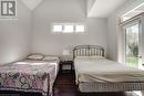 Bedroom featuring wood finished floors, lofted ceiling, and access to outside