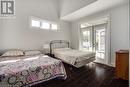 Bedroom featuring access to exterior, wood finished floors, french doors, and baseboards