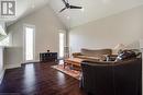 Living room with ceiling fan, hardwood / wood-style flooring, high vaulted ceiling, baseboards, and recessed lighting