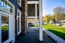 Wooden deck featuring covered porch, a yard, and a residential view