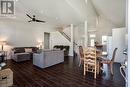 Living area featuring wood finished floors, a ceiling fan, stairway, recessed lighting, and high vaulted ceiling
