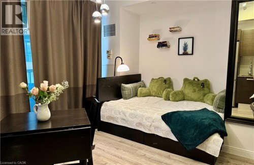 Bed area with vinyl finished floors