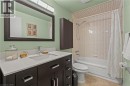 Bathroom with shower / tub combo with curtain, vanity, and light tile patterned floors