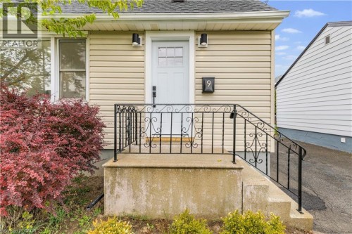 Entrance to property featuring roof with shingles