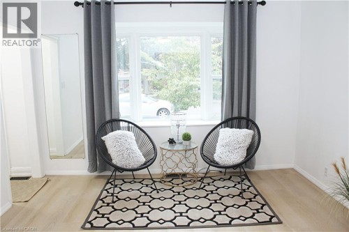 Living Room with wide windows and brand new vinyl floors - fully soundproofed. Blackout curtains included in rent.