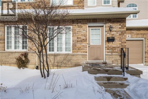 Property entrance with stone siding and a garage