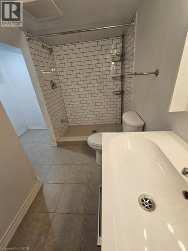 Full bath with vanity, a stall shower, and light tile patterned floors